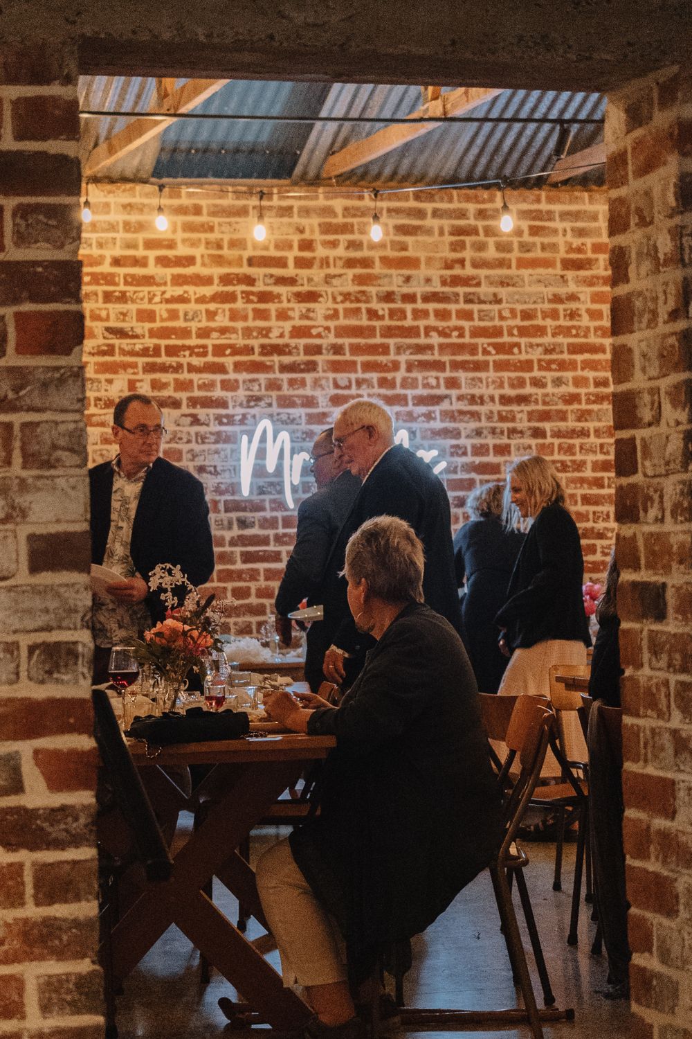 People gathered at a rustic brick venue for an intimate celebration.