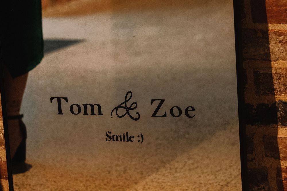 Wedding text reading 'Tom & Zoe Smile :)' displayed in elegant typography against a textured background.