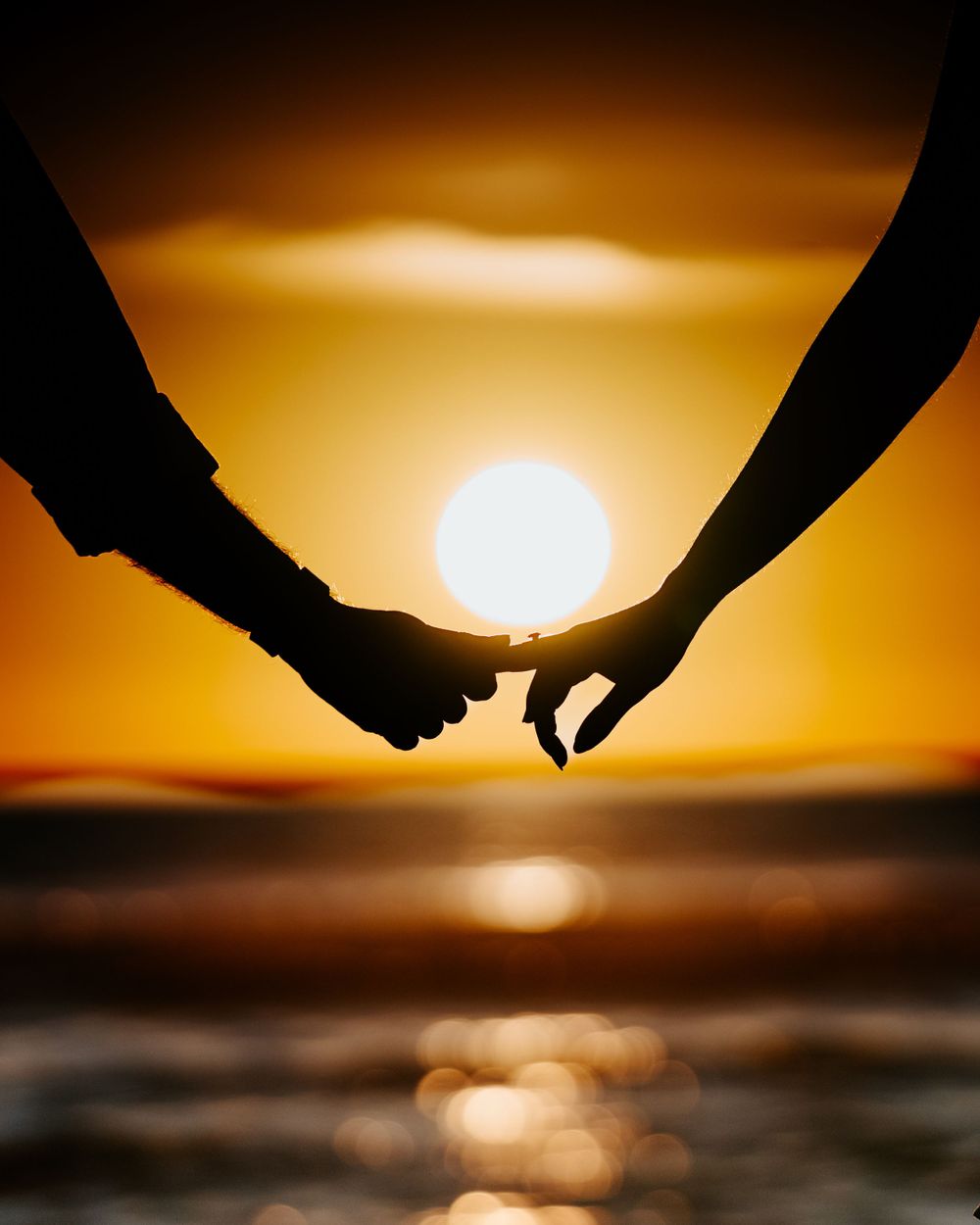Indian couple's romantic engagement silhouette at Los Angeles beach, captured by a Dallas Indian wedding photographer.