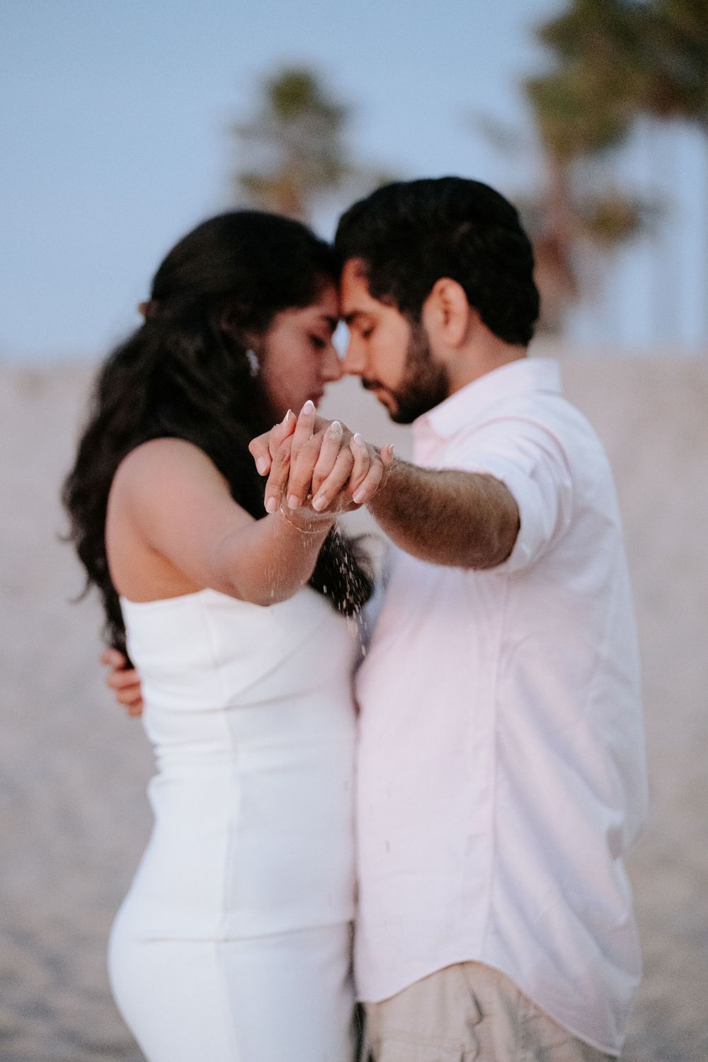 Indian couple's engagement shoot at Los Angeles beach, captured by a Dallas Indian wedding photographer.