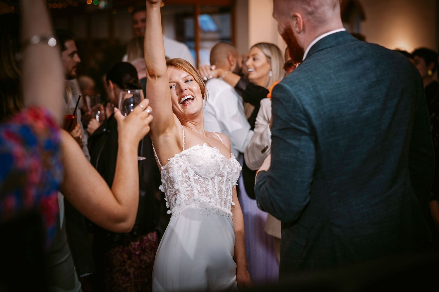 Joyful celebration on the dance floor during an elegant evening wedding reception.