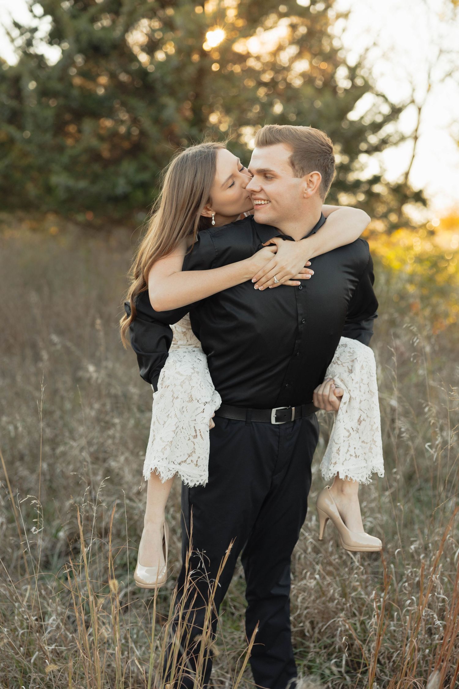 A romantic couple share intimate moments in a sunlit field with autumn grass, captured in a seven-photo series.