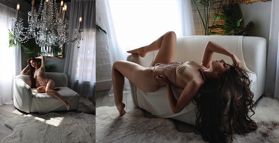 Someone posing artistically on a white sofa in a bright sunlit room.