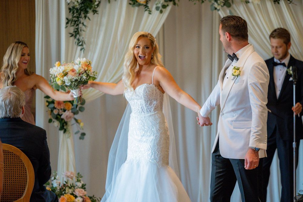 Candid wedding photos of the bride and groom celebrating at their Book Tower Detroit reception.