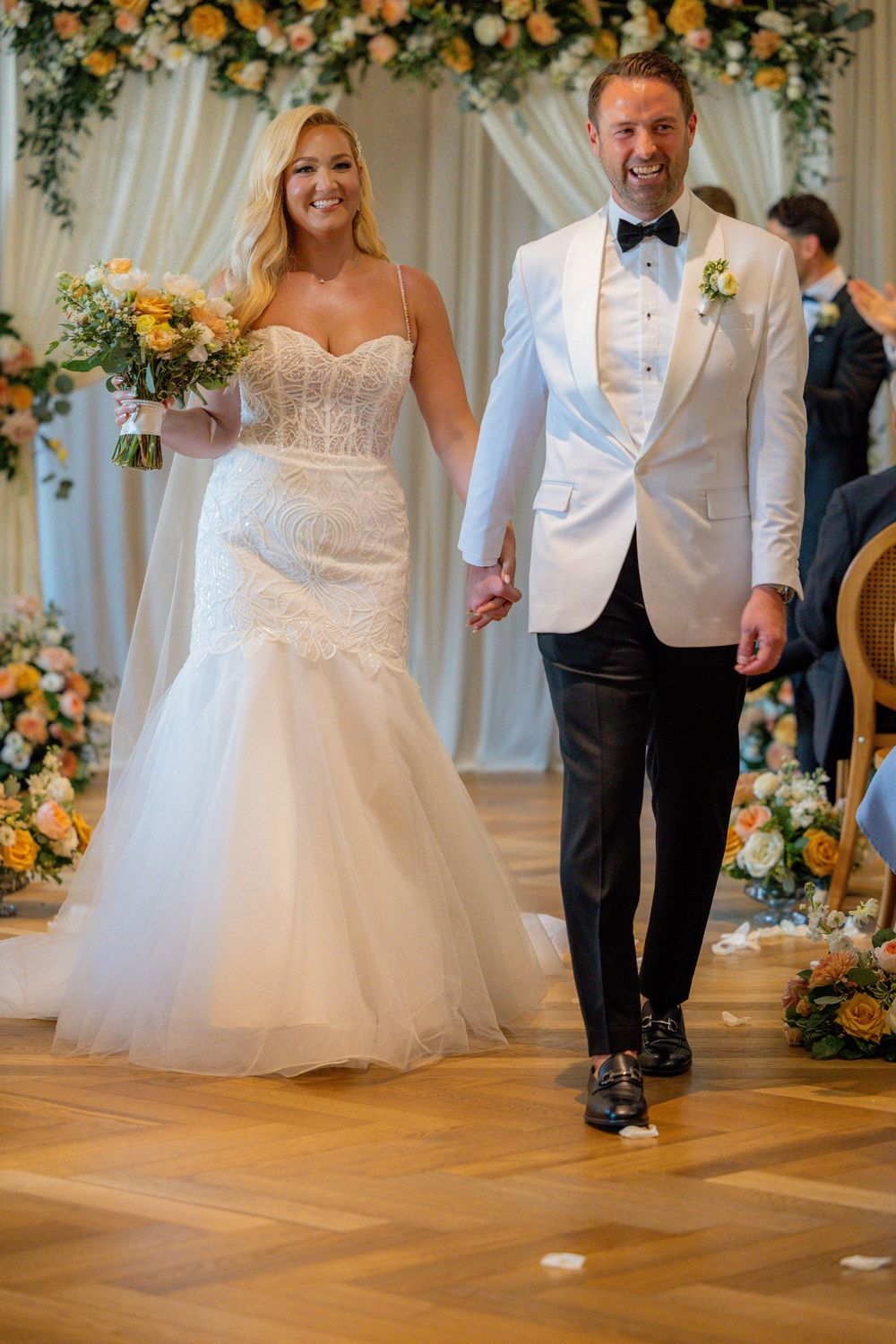 Candid wedding photos of the bride and groom celebrating at their Book Tower Detroit reception.