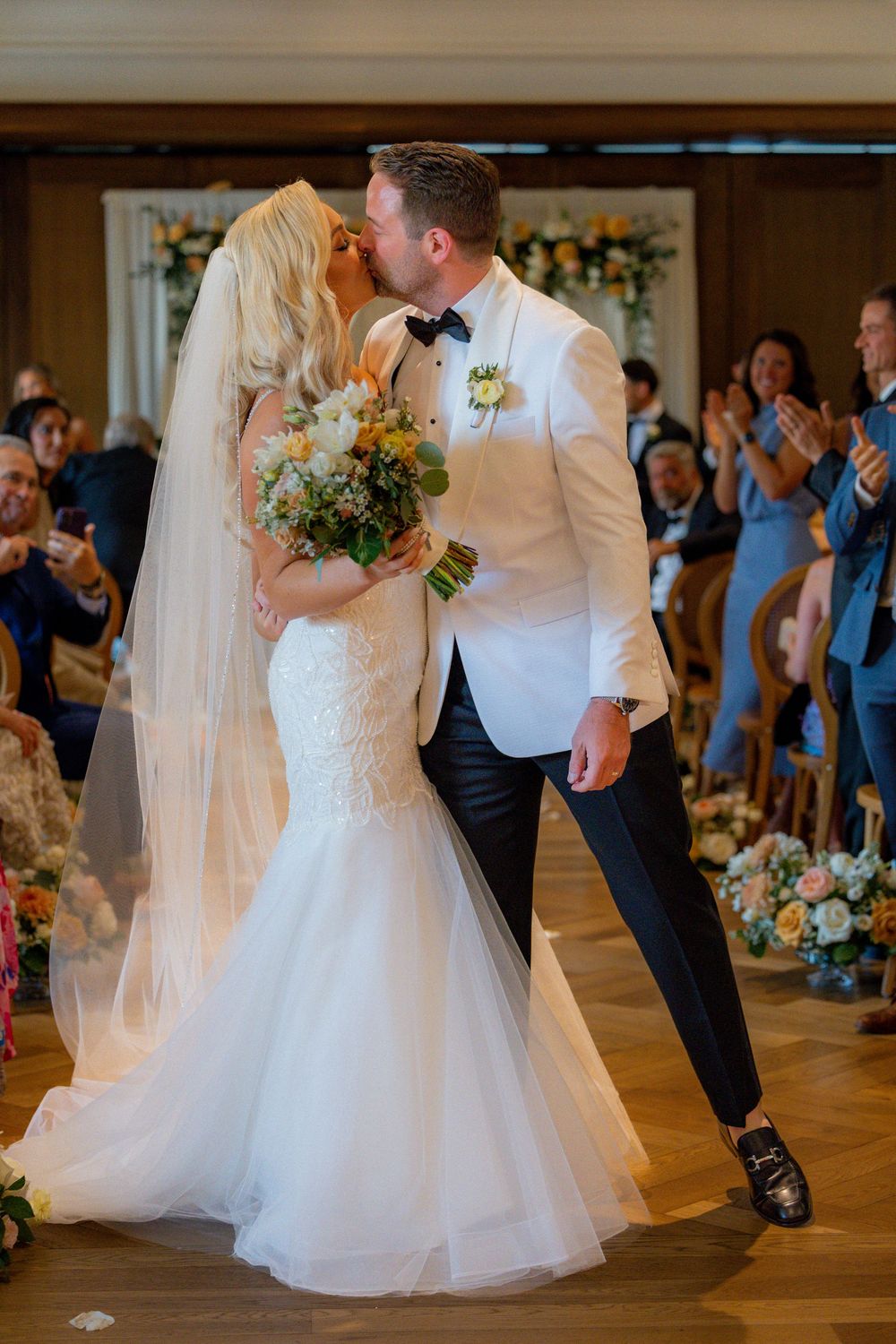 Candid wedding photos of the bride and groom celebrating at their Book Tower Detroit reception.