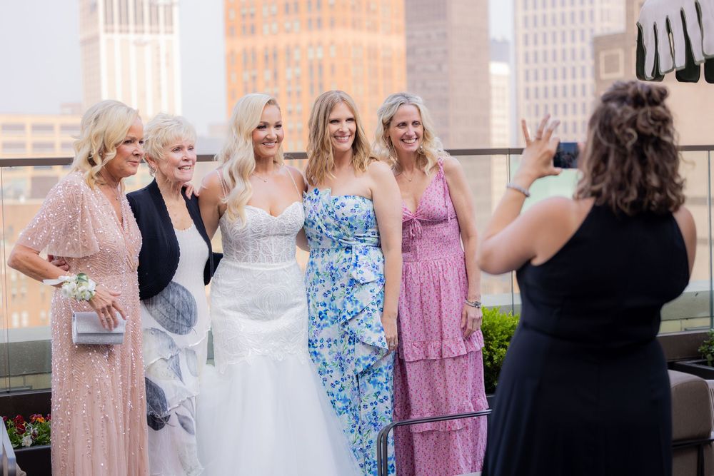 Bride and groom laughing during rooftop wedding photos at Book Tower in downtown Detroit.