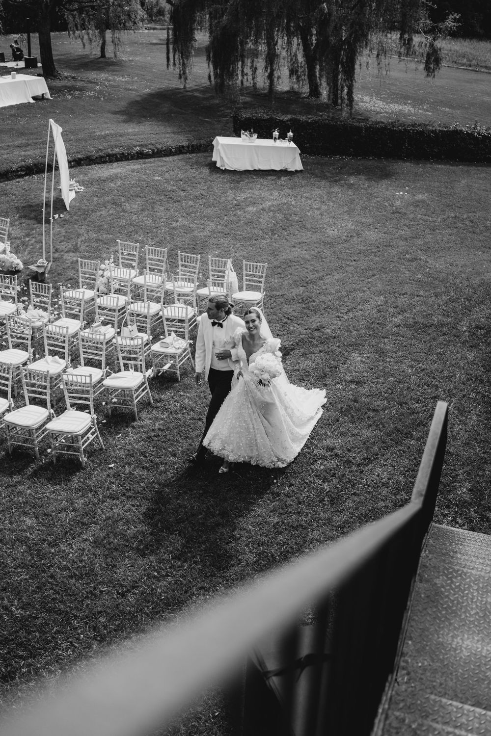 Black and white photo series of an outdoor garden wedding ceremony setup with rows of white chairs on a lawn.