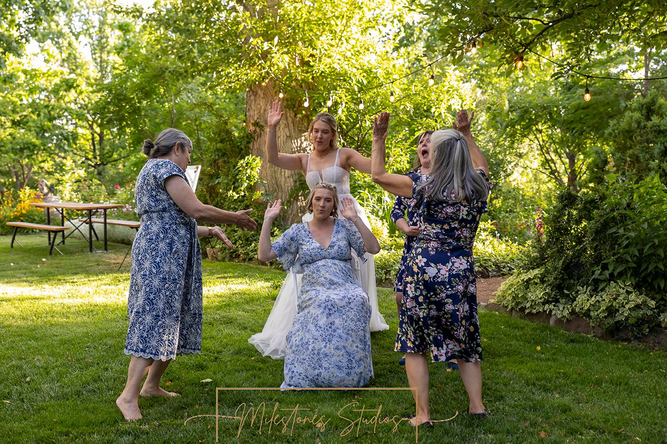 reception dancing around pregnant woman sitting in chair