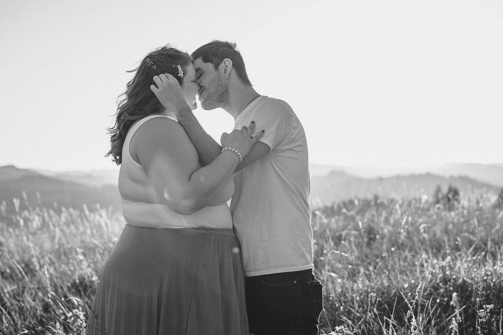 A romantic black and white series of photographs showing intimate moments between a couple in a scenic outdoor setting.