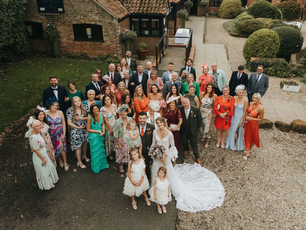 Aerial view of wedding guests gathered in courtyard at Hall Farm - image captured by Grimsby photographers.