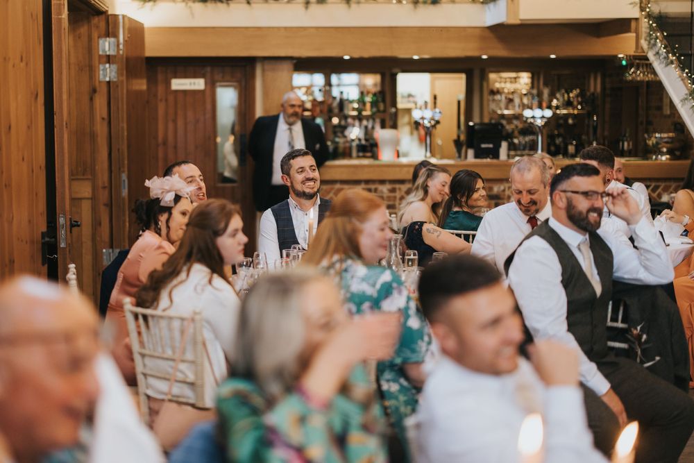 A lively room filled with joyful wedding guests celebrating at Hall Farm - image captured by Grimsby photographers.