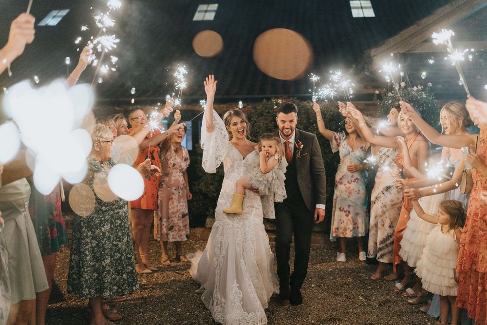 Wedding guests hold sparklers creating a magical tunnel walkway at Hall Farm - image captured by Grimsby photographers.