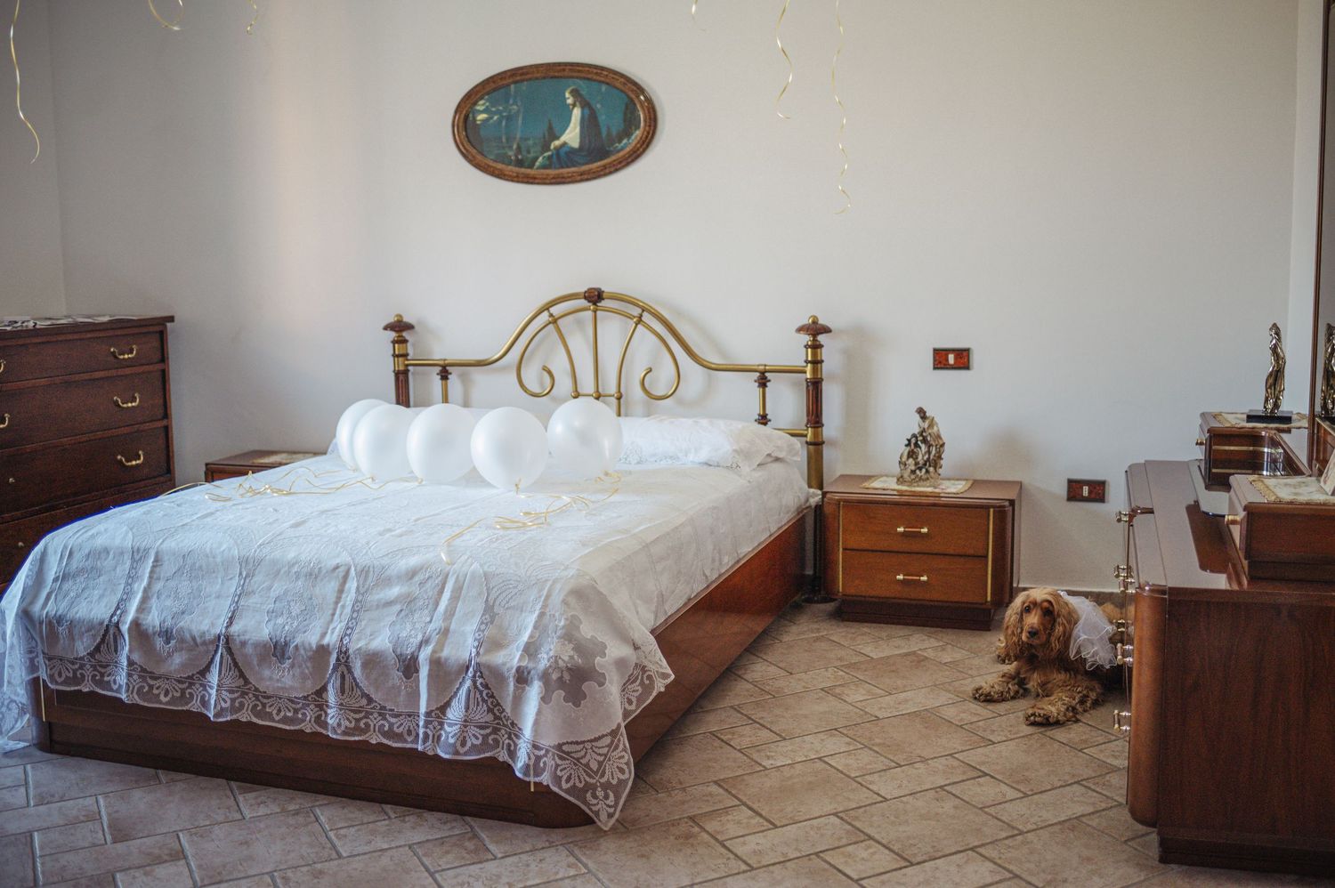 A spacious bedroom with traditional furniture and white bedding.