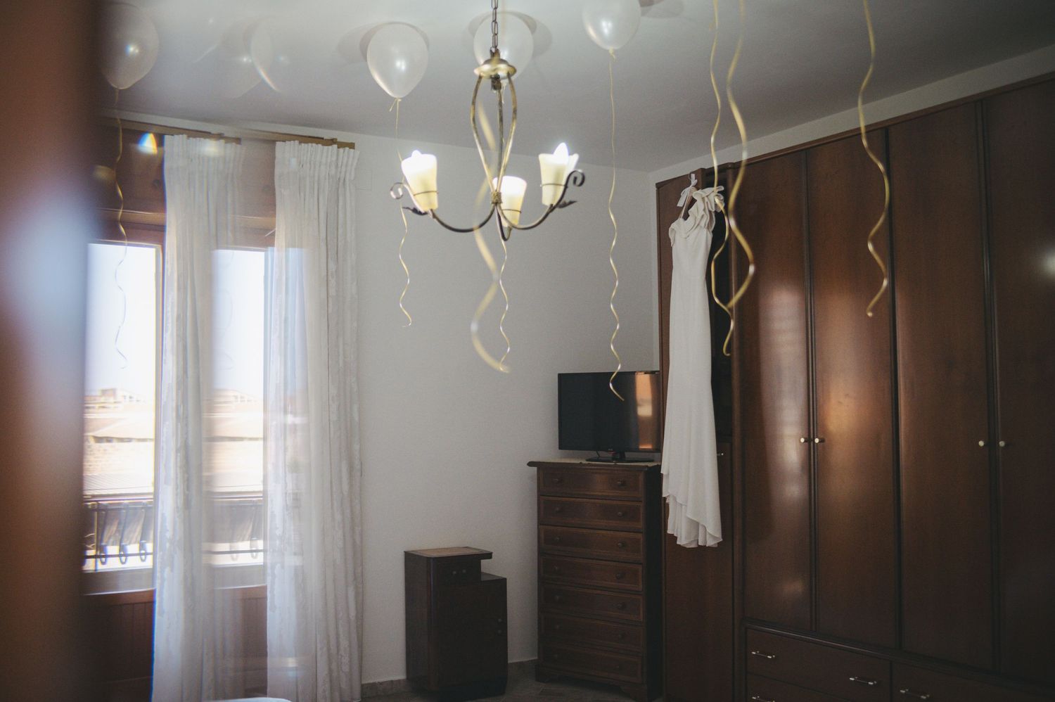 An elegant room interior with hanging decorative elements and warm lighting.