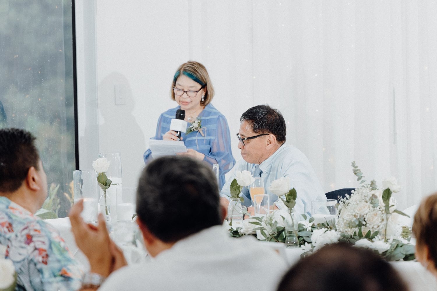 Wedding reception scene with speakers at a table captured by Apertured Media Auckland Wedding Photographer.