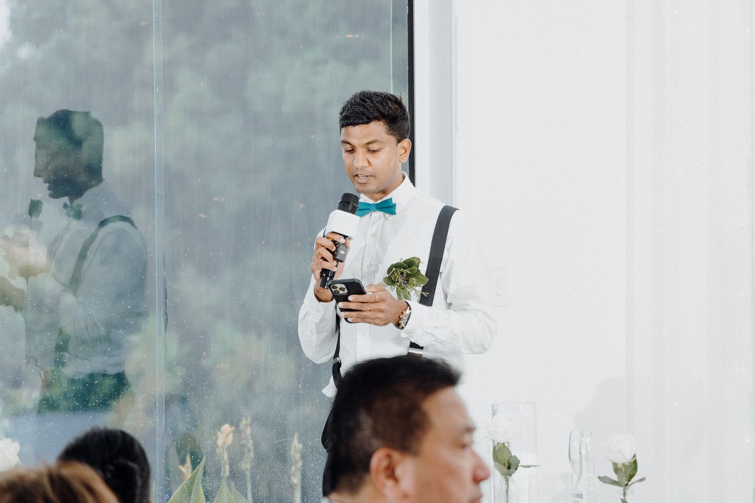 A groomsmen delivering his speech for the bride and groom captured by Apertured Media Auckland Wedding Photographer.