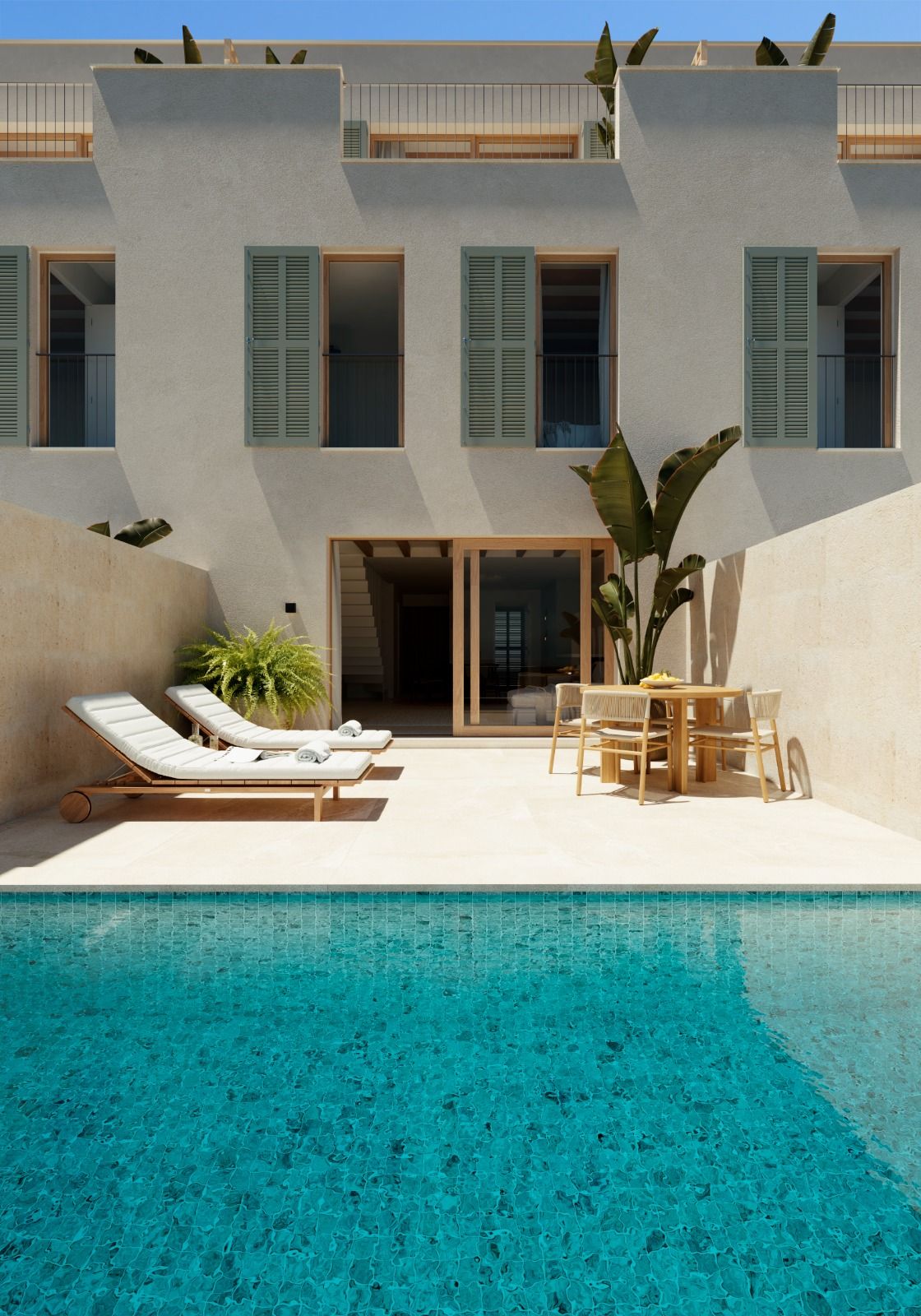 Modern white villa with turquoise pool, sun loungers and tropical plants in minimalist courtyard setting.