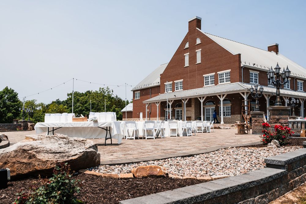 Panoramic view of a brick church building with white columns and walkway.
