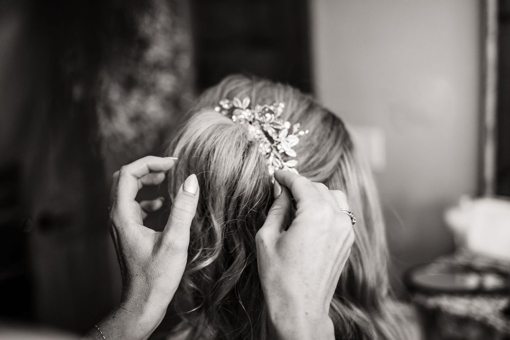 Close-up shot of someone getting their hair styled with delicate accessories.