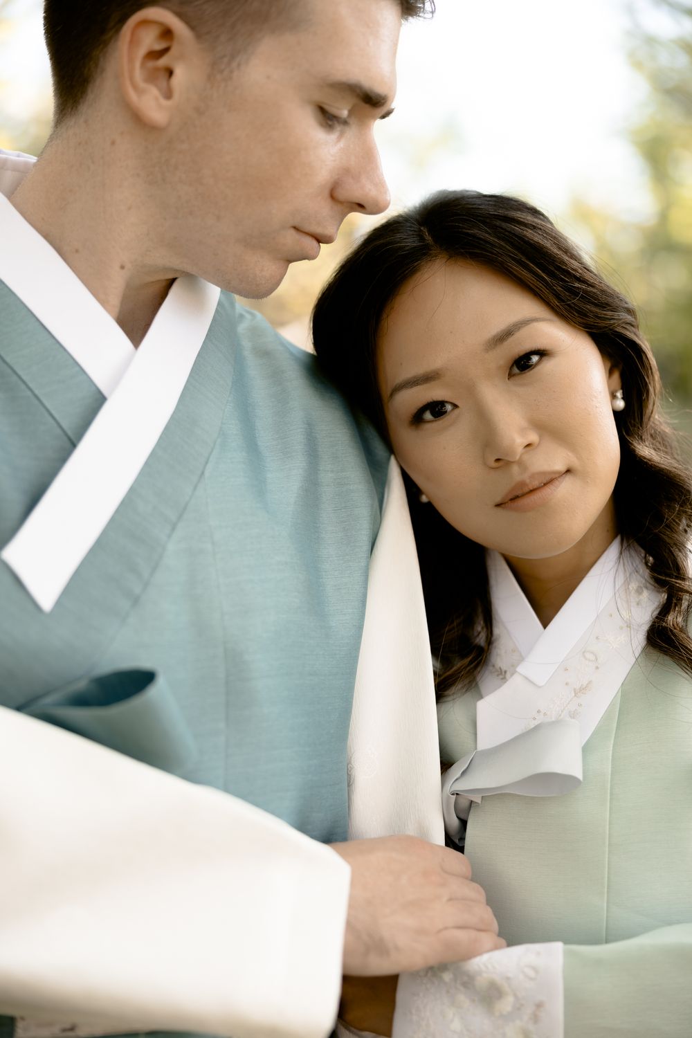 Intimate portrait of a couple wearing traditional Korean hanbok attire. Athens wedding photographer Pyrgos Petreza