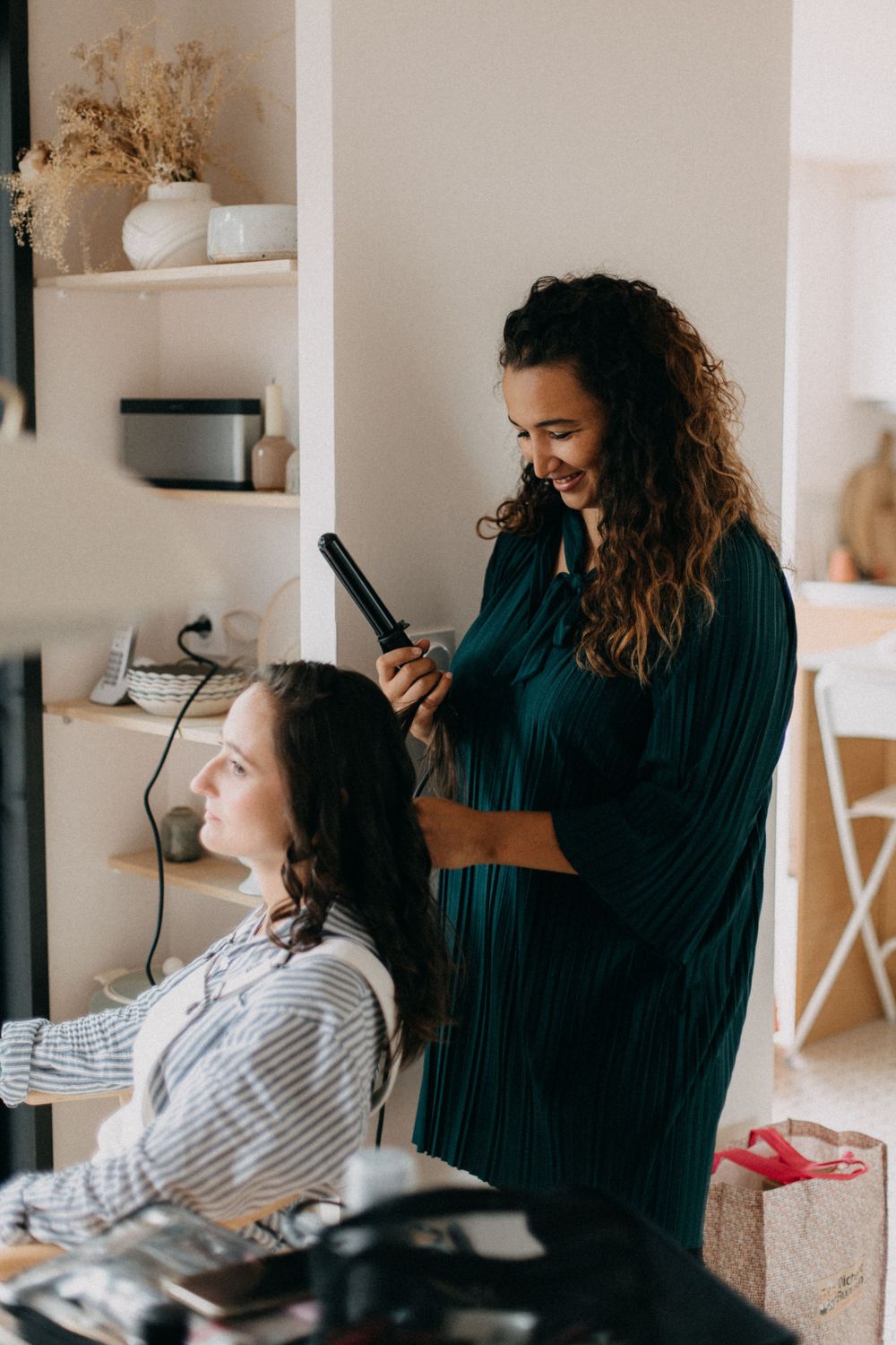 Hair styling session in progress at bright indoor location with modern decor.