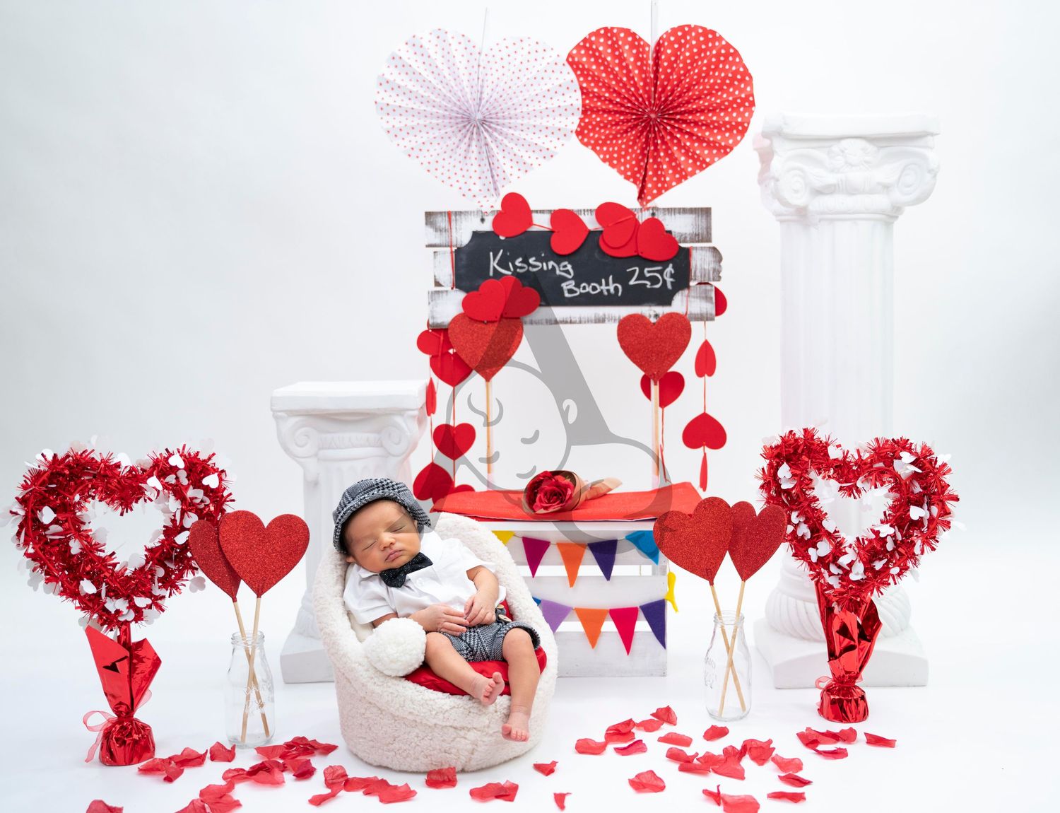 Valentine's day themed photography setup with red hearts, paper decorations, and white pillars.