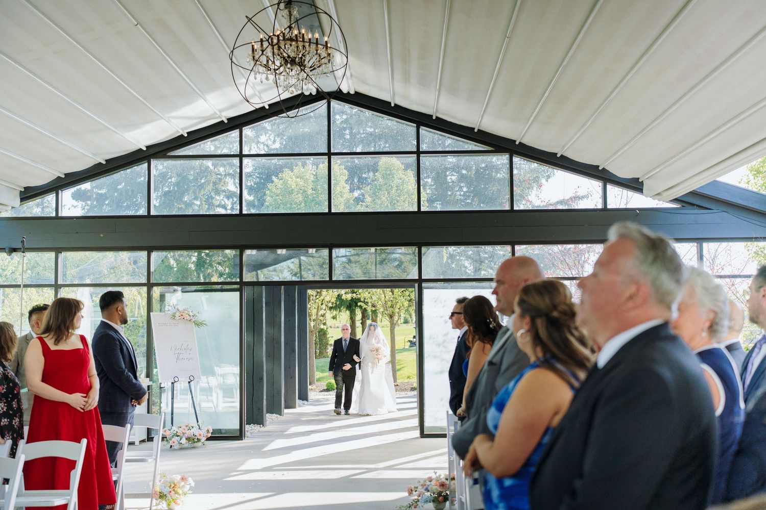 Wedding venue with white ceiling panels, crystal chandeliers and panoramic windows.