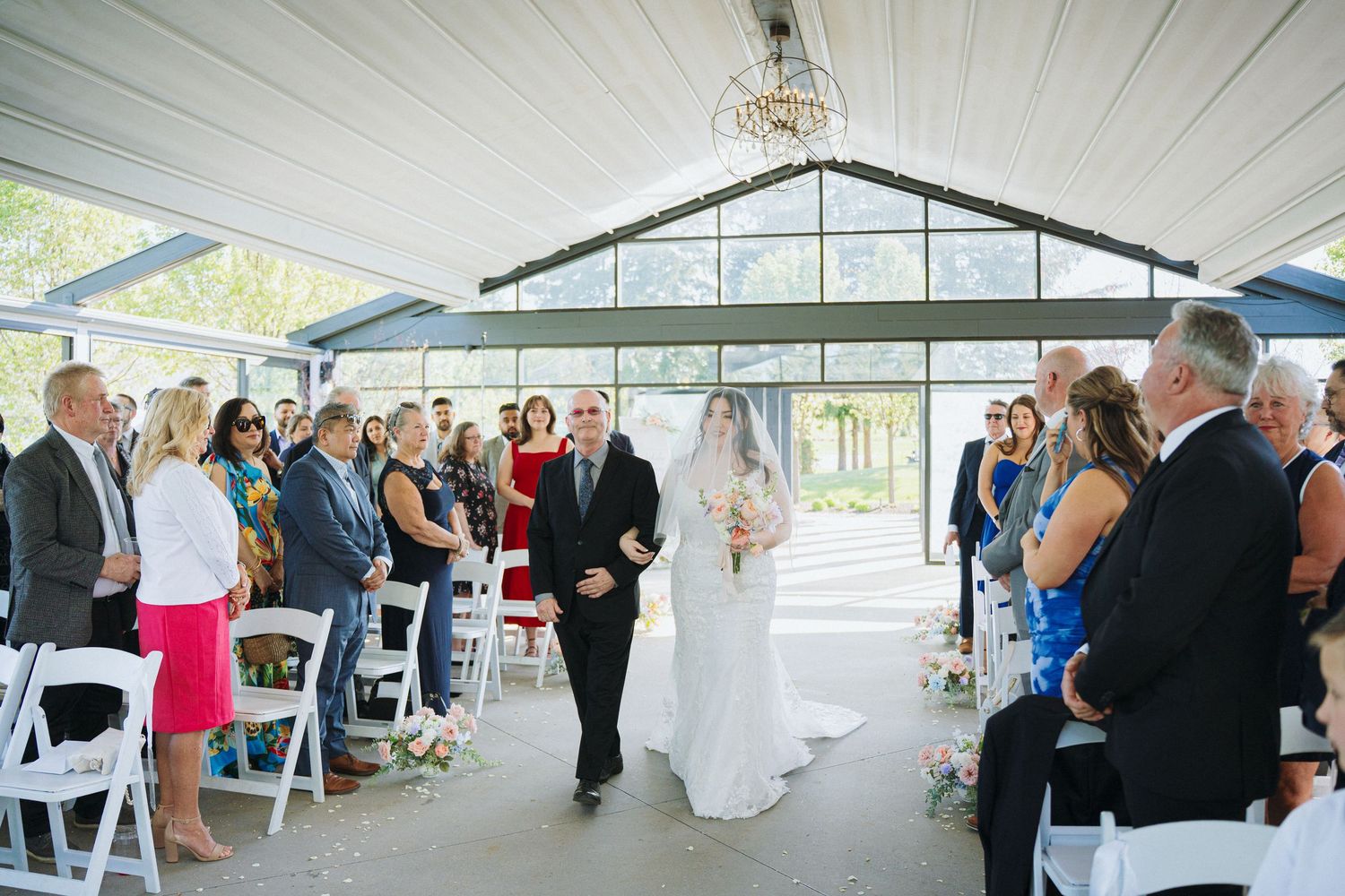 Panoramic view of wedding reception space with white decor and modern architectural elements.