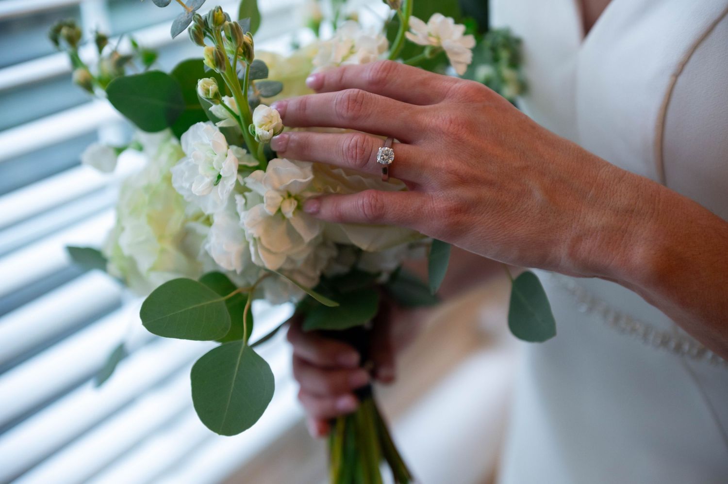Groom adjusting boutonnière before ceremony at Jupiter Beach Resort, styled by top Jupiter wedding photographers.