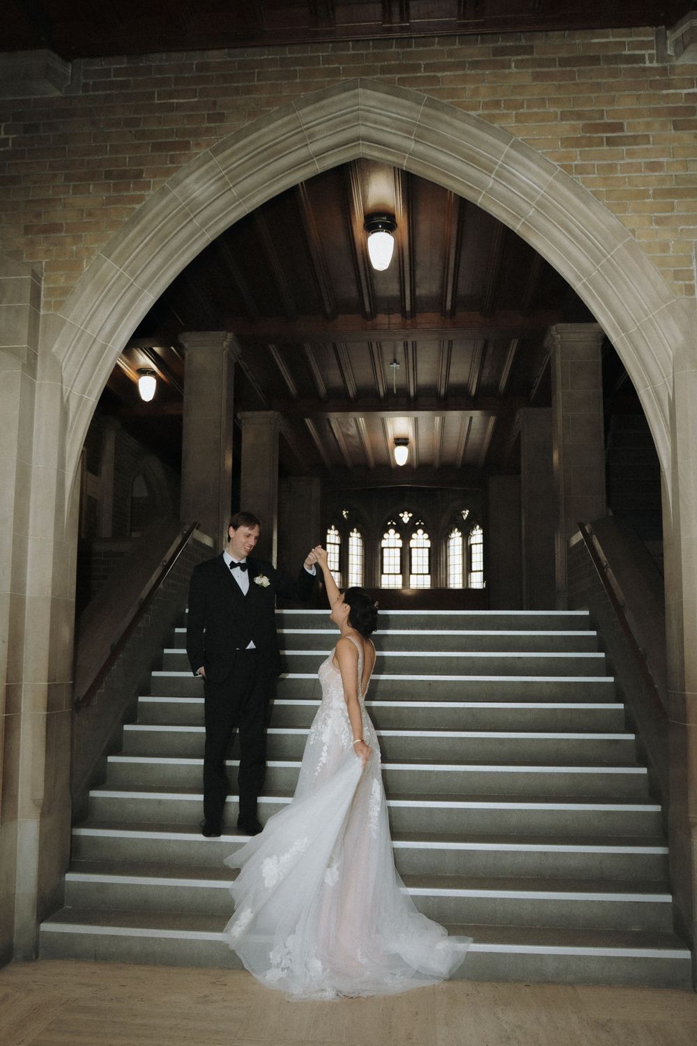White stone archways and steps create a dramatic backdrop for wedding portraits.