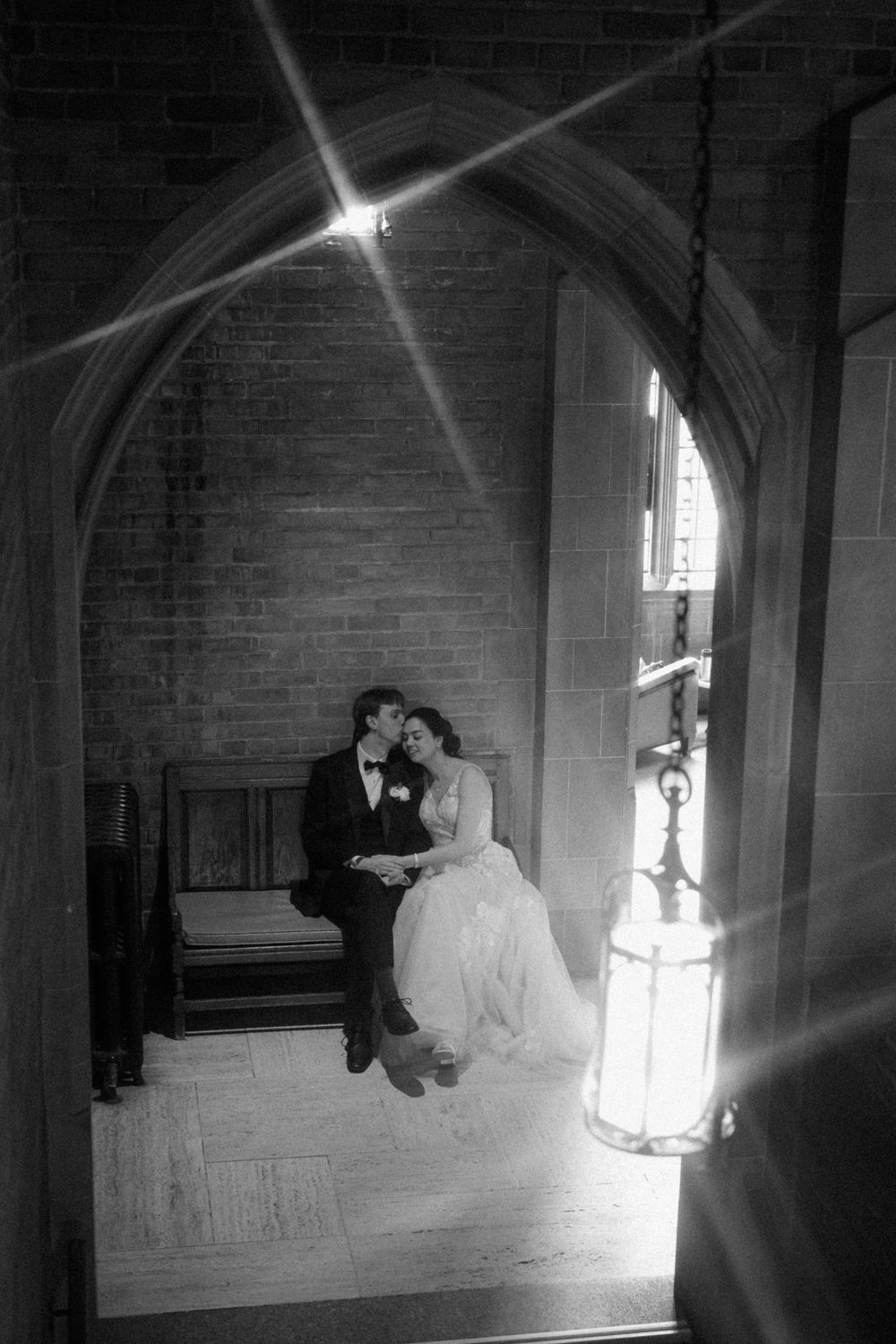 Sunbeams stream through windows creating dramatic lighting for wedding photography.