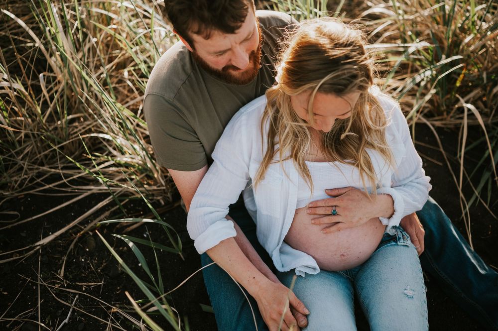 Maternity session couple holding belly in beach grass in Union Bay on Vancouver island Maternity and Outdoor natural light photographer