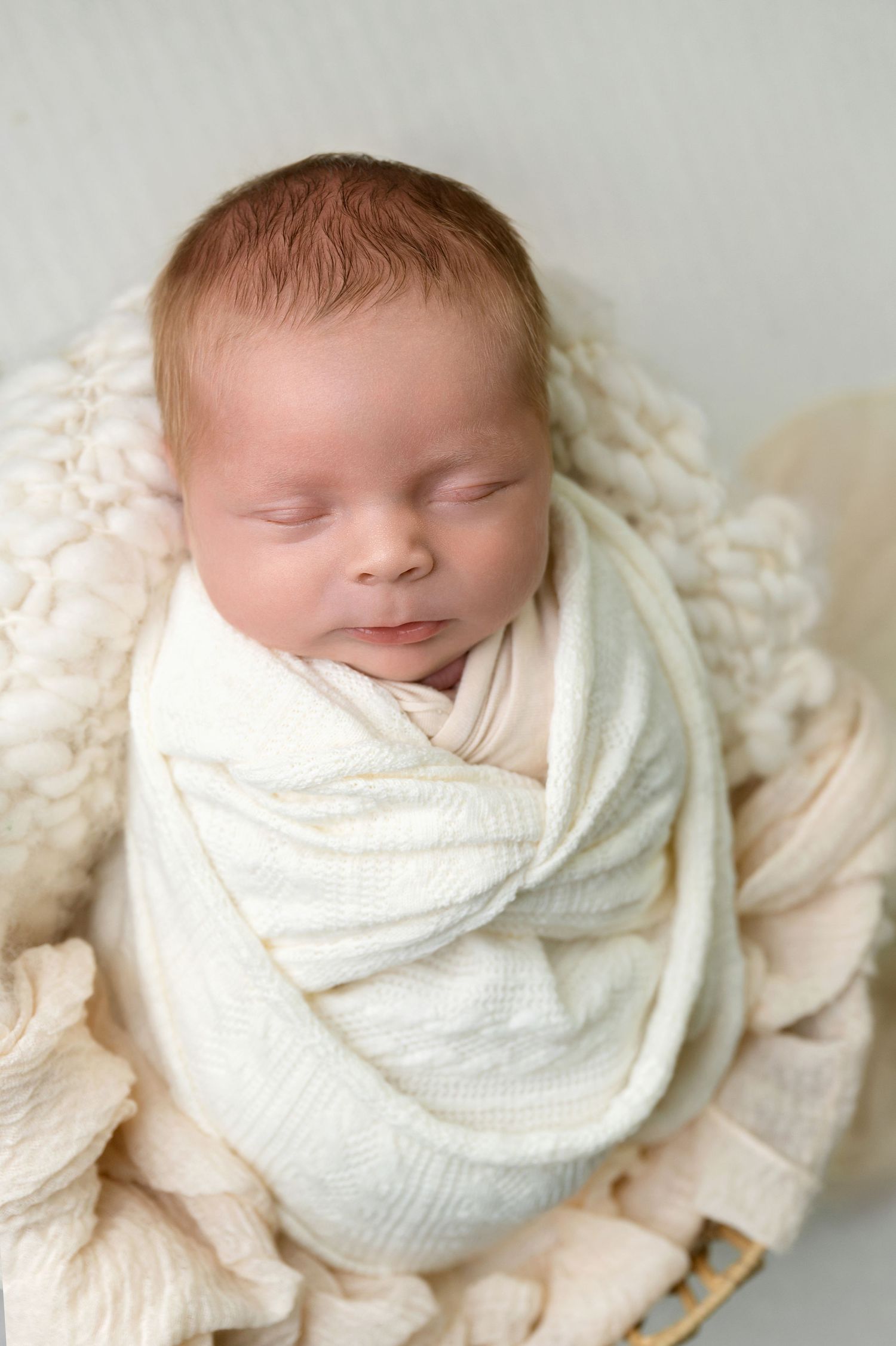 A black and white collage of intimate newborn photography portraits displayed in an artistic arrangement.