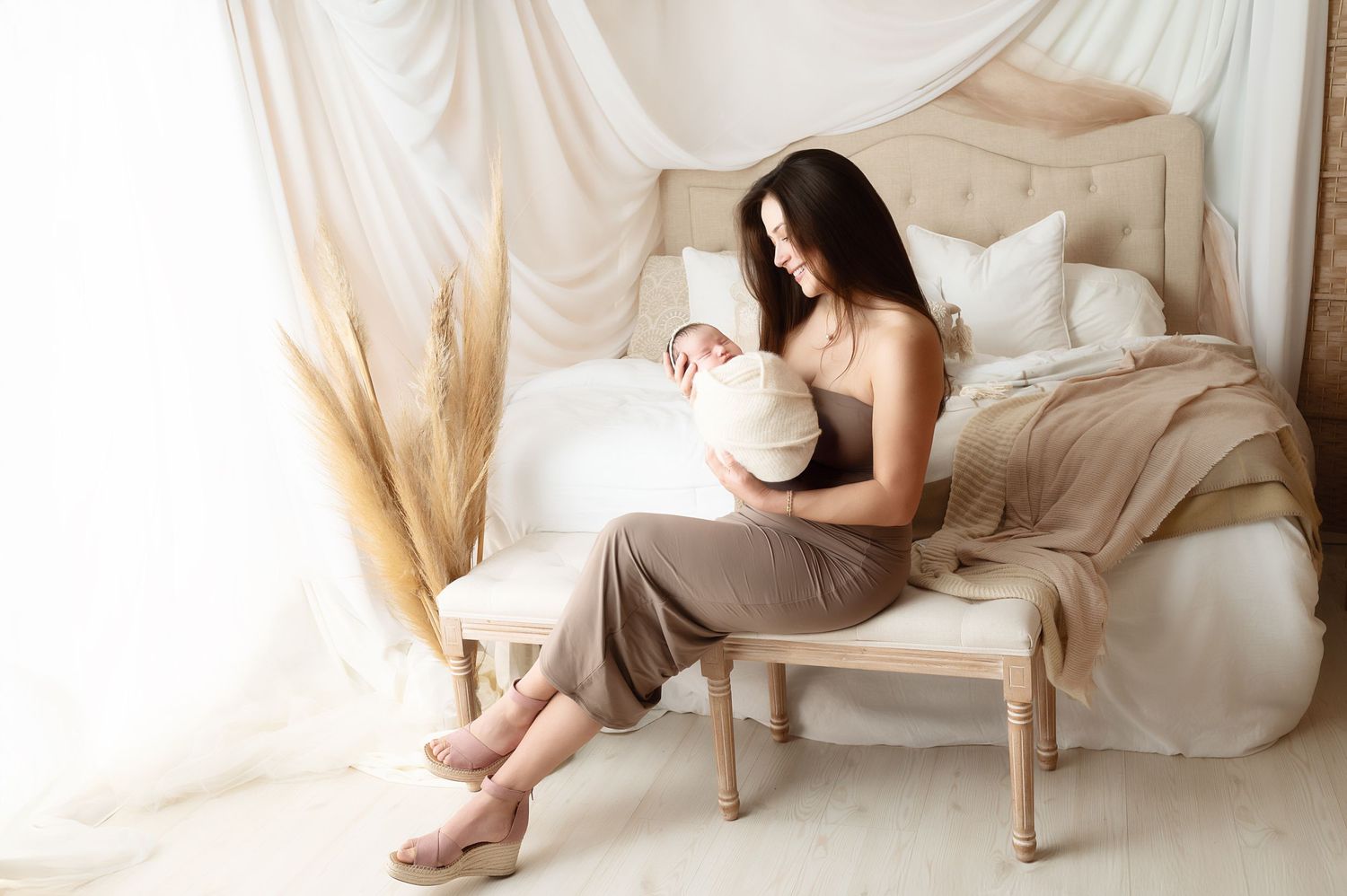 Studio maternity session featuring flowing fabrics and elegant neutral tones.