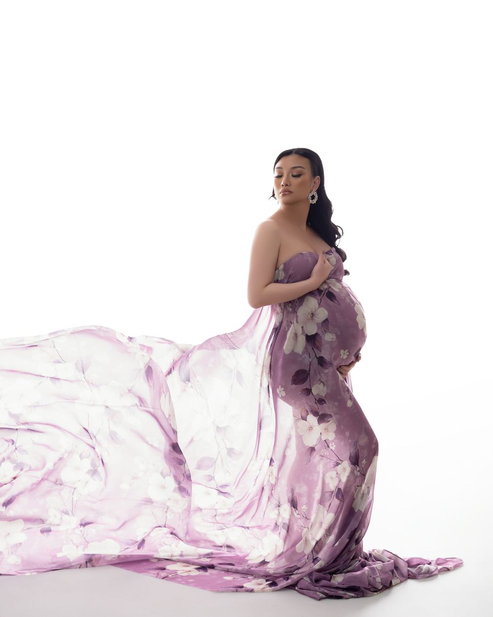 A flowing purple and white watercolor gown creates ethereal movement across a series of artistic fashion portraits.