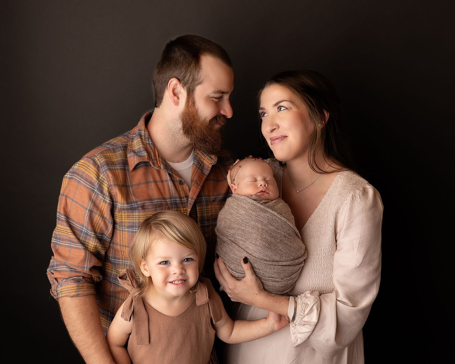 Professional photo of a newborn baby and her family