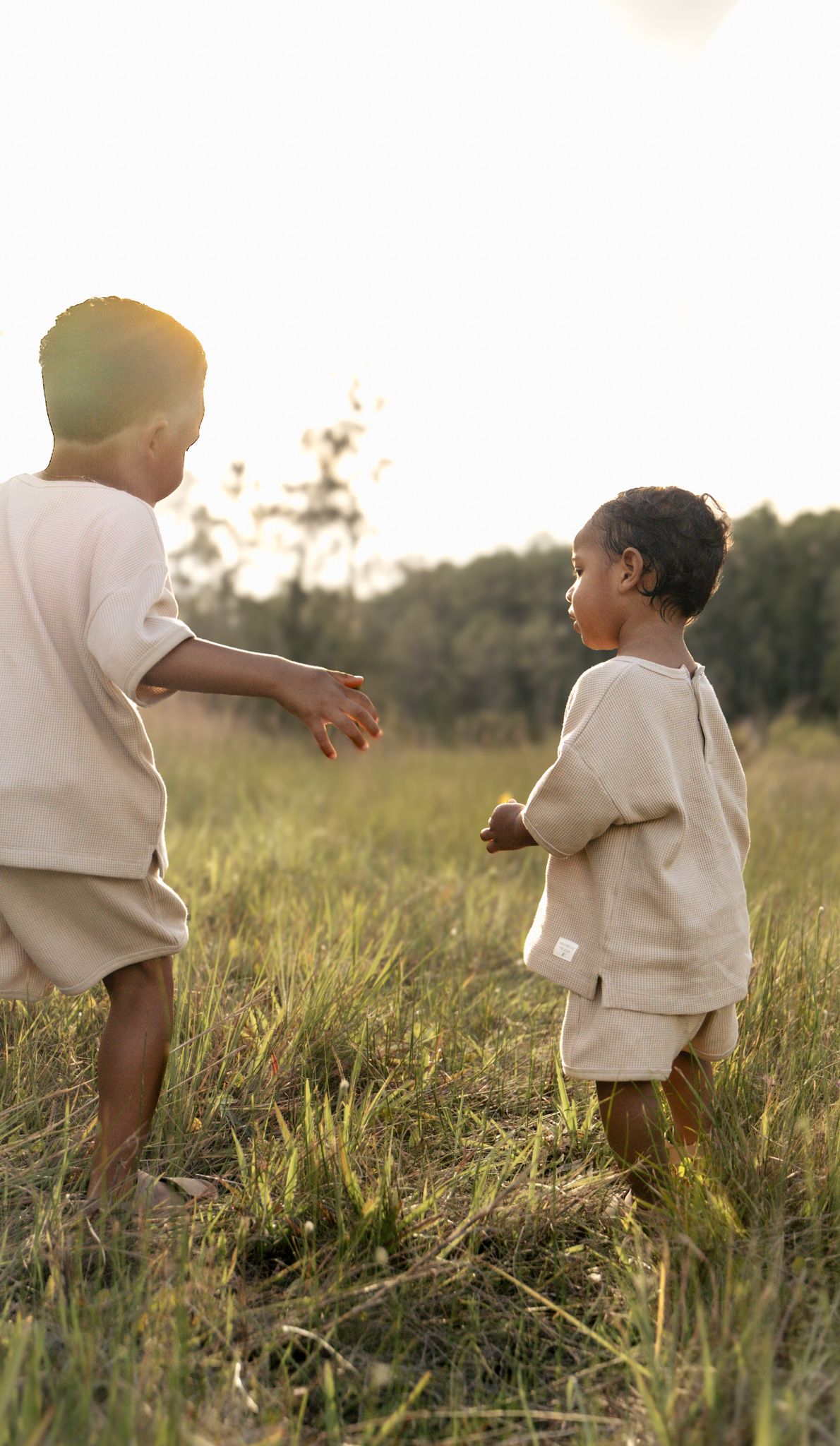 Brothers playing in grassy field photo idea