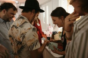 A candid party scene with guests gathered in close conversation.