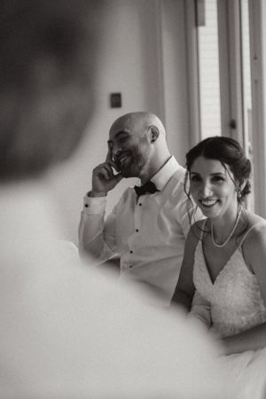 A couple shares a joyful moment together during their wedding reception.