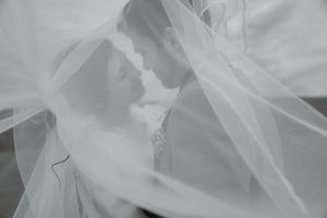 Ethereal black and white photo of veils flowing in the wind creating a dreamy effect.