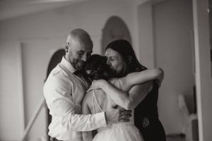 A tender embrace shared during an emotional wedding moment.