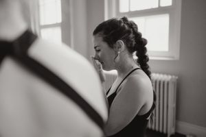 Black and white portrait showing a woman's profile near a window.