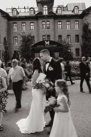 A wedding scene outside Hotel Vermont with guests gathered around the newlyweds.