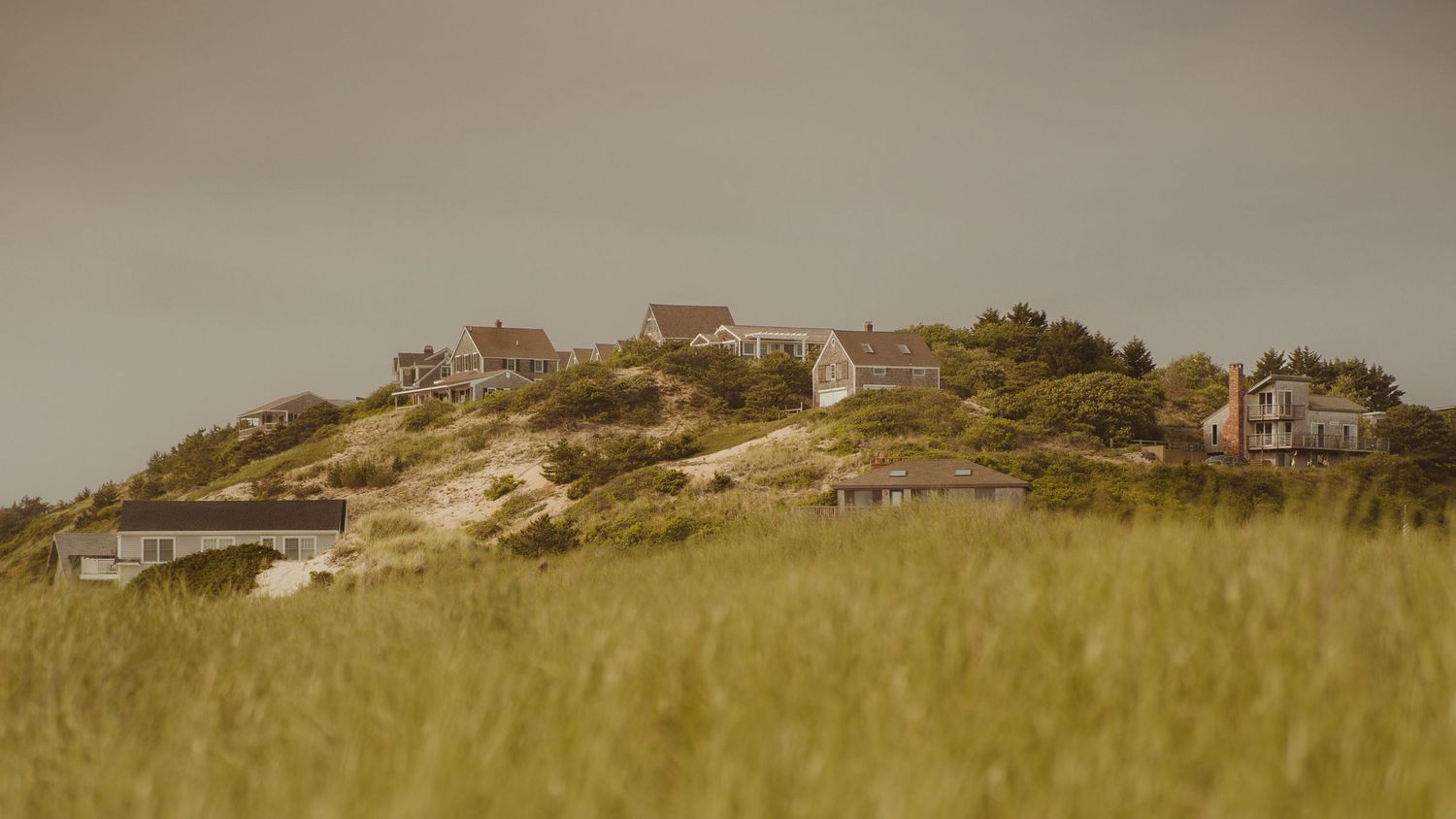 a beautiful landscape photo of several houses along a Massachusetts beach