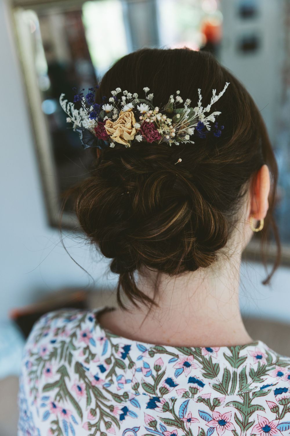 Delicate floral hair accessory adorning elegant bridal updo.