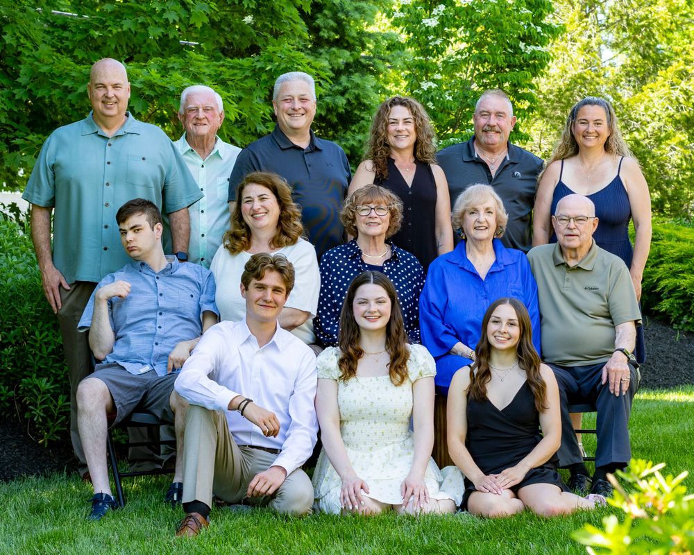Extended family portraits at a graduation party in Sudbury, MA in Metrowest of Massachusetts. Event photographer with posed family photo.
