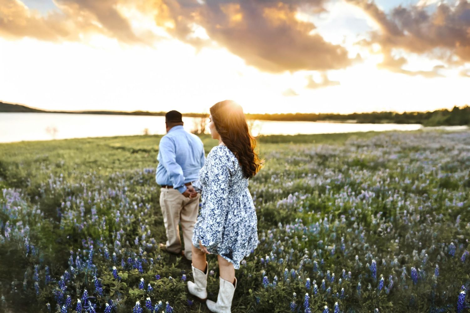 Couple laughing and dancing among vibrant bluebonnets at golden hour on the scenic Ennis Bluebonnet Trail
