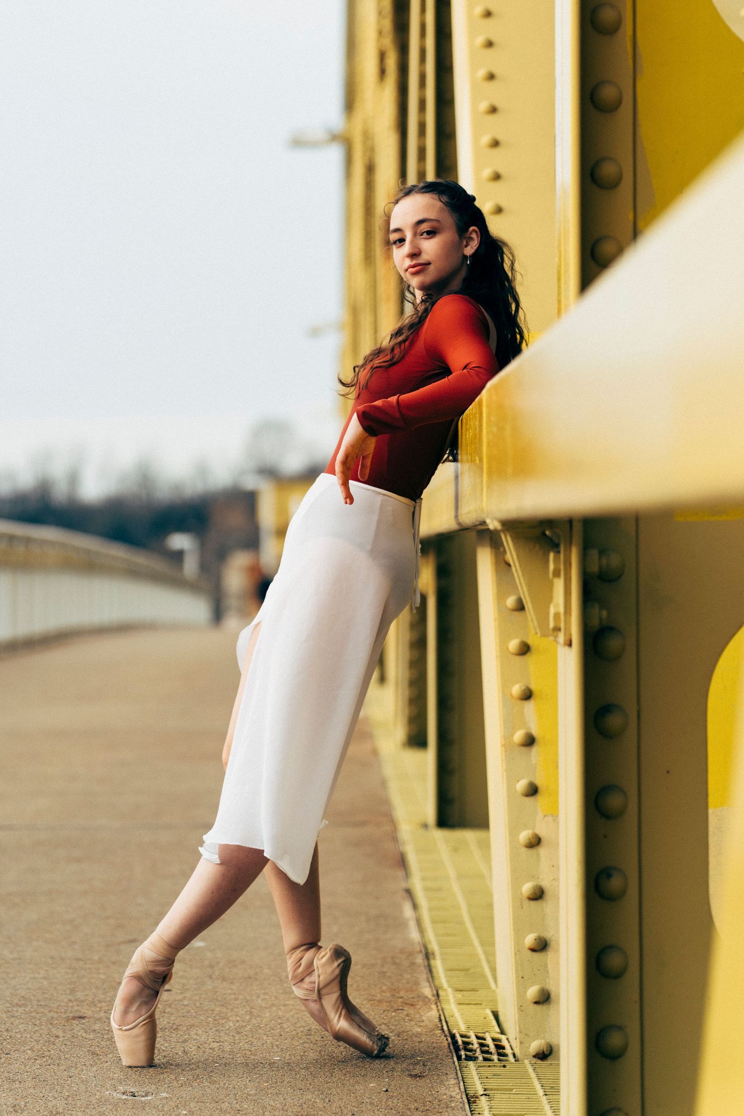Dramatic ballerina portrait captured by Pittsburgh dance photographer in natural light on a bridge pittsburgh dance photographer