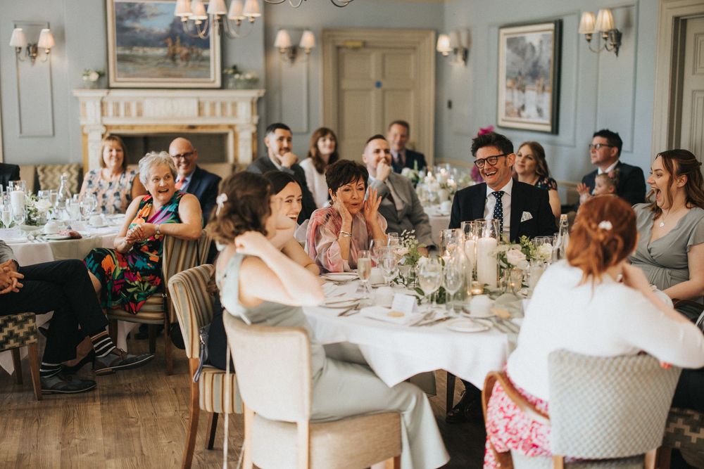 Guests gathered around elegant tables at an upscale wedding reception dinner at Washingborough Hall - taken by Grimsby photographer.